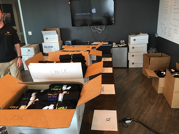 Fundraiser shirts being packed by hand